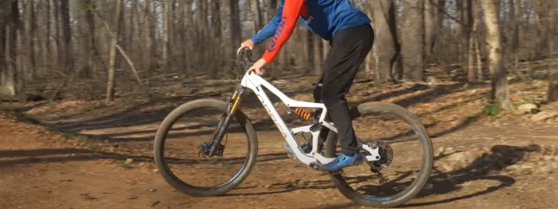 A bike's suspension fork working on a rough trail