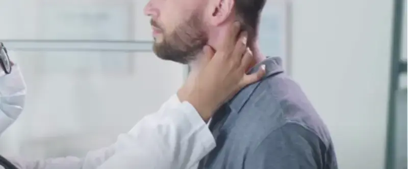 A cyclist checking for swollen glands in their neck