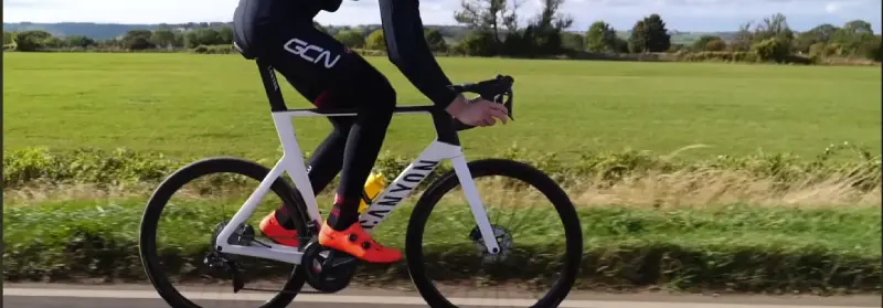 A cyclist climbing a steep hill to build calf strength