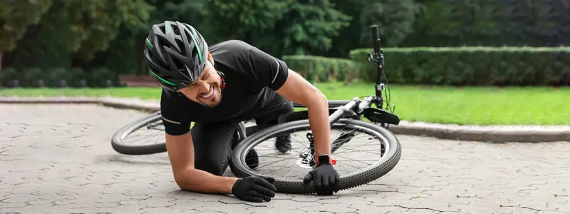 A cyclist looking dizzy or experiencing vertigo