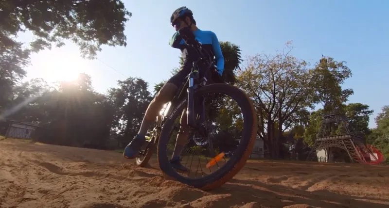 A cyclist taking a break in the shade to cool down