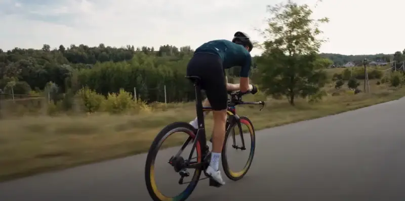 A cyclist with proper, relaxed posture on their bike
