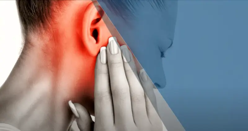 A person holding their ear and neck, showing referred pain