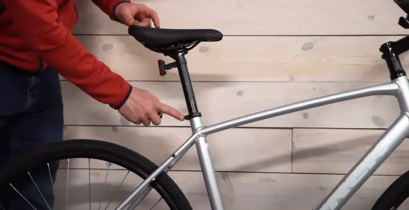 A professional bike fitter adjusting a bike saddle
