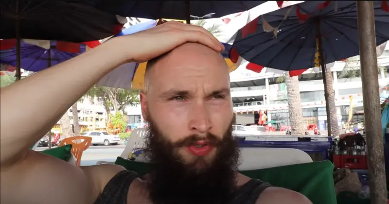 Close-up of a cyclist’s shaved head wearing a helmet