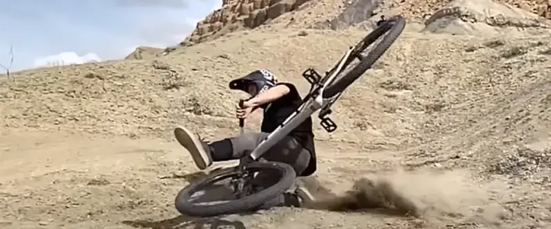 Cyclist holding head after accident with headache symptoms