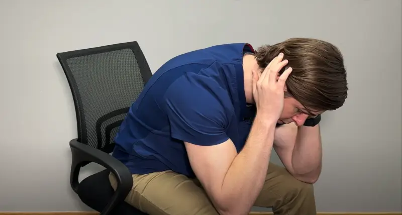 Cyclist holding head after fall from bike