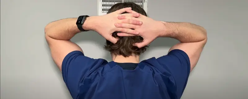 Cyclist massaging their own neck to relieve a pinched nerve
