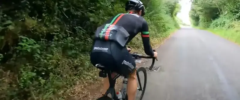 Cyclist resting after head injury with helmet on the ground