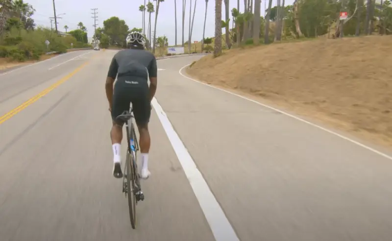 Diagram of poor cycling posture causing back strain
