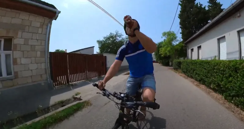 Staying hydrated by drinking water during a hot ride