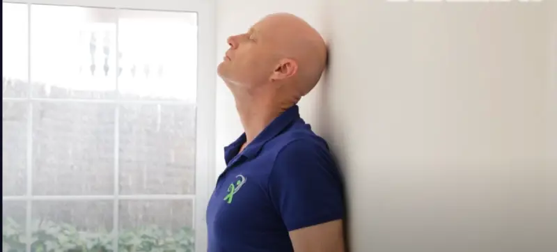 Woman doing a gentle neck stretch to ease muscle tension